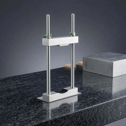 Cello Head Clamp For Violin Family Instruments Go To Pro Luthier Bench Fixture With Secure Holding And Repeatable Positioning For Instrument Building And Repair In Workshop With Cushioned Touch Area silver metal clamp on granite workbench