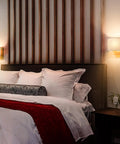 Hot Gold Brass Wall Sconces Set Of Two Drum Shade Mid Century Modern Lighting in bedroom with wood panel backdrop
