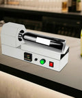 Electric PVC Wine Bottle Capsule Heat Shrinker, Tabletop Label Sealing Machine on bar countertop with wine bottle.