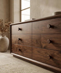 Top Shelf Mid Century Modern Walnut Mushroom Cabinet Knobs Slick Round Drawer Pulls on a walnut dresser in a living room setting.