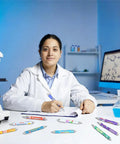 Science Theme Ballpoint Pens 10 Pack Colorful STEM Design Pens With Lab Icons on a lab desk with a scientist writing.
