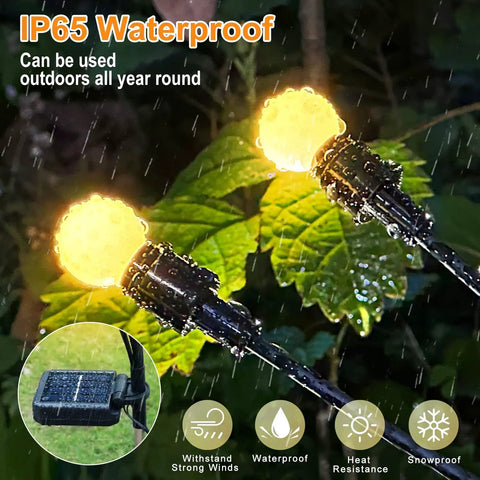 Four Pack Solar Garden Path Lights With 8 LED Firefly Glow Waterproof Outdoor Yard Decor glowing in rain over green leaves
