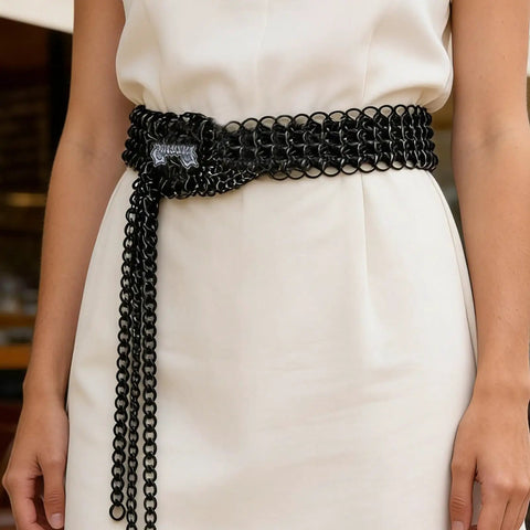 Premium Industrial Steel Punk Metal Belt In Matte Black With Easy Hook And Loop Sizing For Badass Gothic Streetwear Fits and rugged everyday flex style, styled on white dress.