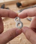 Hands holding Heavy Duty Dual Hole Rock Solid Desk Fasteners With Screws Clips 30 Pcs Iron Tabletop Connectors Prepunched No Burrs