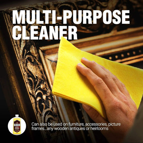 Hand using yellow cloth to apply Antique Restoration Wood Polish And Cleaner Delivers A Top Shelf Formula Loaded With Real Organic Oils For Furniture Care While Knocking Out Grime And Leaves A Hella Smooth Protective Shine On Every Surface on a decorative frame.