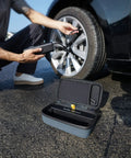 Officially Customized EVA Storage Case For X8 APEX Tire Inflator And S100 Kit on the ground near inflating tire