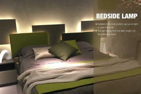 Bedroom with green bed and illuminated headboard; bedside lamp visible behind pillow.