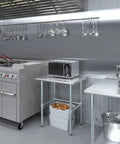 24 Inch By 30 Inch Heavy Duty Stainless Steel Work Table With Open Base For Commercial Kitchens And Garage Workshops, utility station with a microwave.