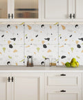 White kitchen cabinets with terrazzo backsplash and matte black cabinet knobs.