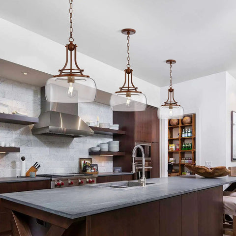 Rustic Farmhouse Industrial Round Ceiling Pendant Light With Clear Glass Shades over a kitchen island.