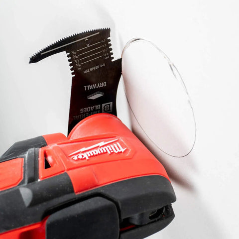Close-up of Heavy Duty 4 In 1 Drywall Blade Equipped With A Precision Dagger Tip And Built In Depth Marker cutting drywall.