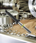 Magnetic Pickup Tool Wand With Release Handle For Nails Screws And Metal Scraps in workshop with metal shavings.