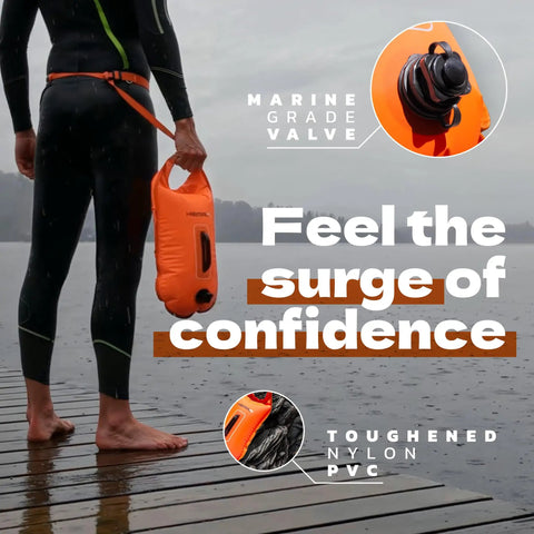 Person holding Open Water Swim Buoy With 15L Dry Bag and Rest Handle, fully waterproof swim bubble, high visibility orange.