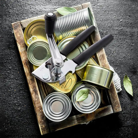 Heavy Duty Manual Can Opener With Rubber Coated Long Handles, Commercial Grade Squeeze And Crank Can Opener on a tray with cans