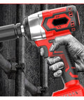 Gangsuqd Cordless Brushless Impact Wrench Offering High Torque And Multi Function Power For Car Repair held in hand against metal background.