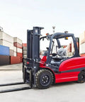 Heavy Gauge Mini Electric Forklift 2500 Lb Pallet Stacker built tough as nails in a warehouse with cargo containers.
