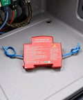 Automatic Car Fire Extinguisher Compact Aerosol Unit With Slick Peel Stick Install For Instant Flame Stop and Solid Vehicle Safety Hassle Free Essential Emergency Ride Guard Gear mounted on surface in vehicle.