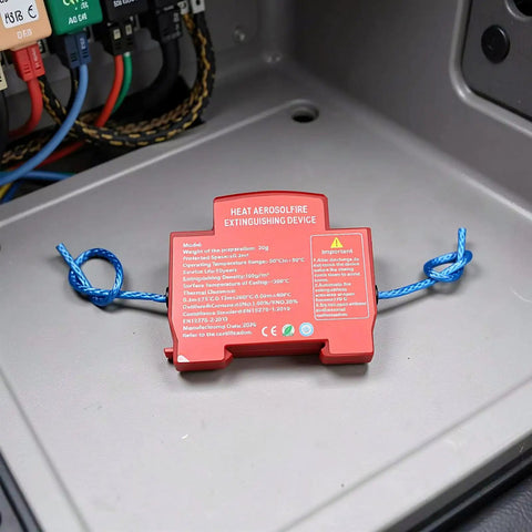 Automatic Car Fire Extinguisher Compact Aerosol Unit With Slick Peel Stick Install For Instant Flame Stop and Solid Vehicle Safety Hassle Free Essential Emergency Ride Guard Gear mounted on surface in vehicle.