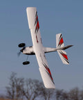 RC Airplane Apprentice STOL S 700 RTF With AS3X SAFE Technology flying mid-air showcasing its red and white wings.