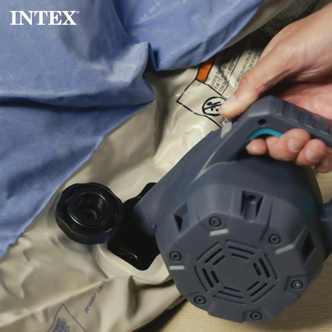 Hand using Indoor 120 Volt AC Inflatable Pump For Pools Floats And Air Beds Fast Inflate Deflate 38.9 CFM Three Interchangeable Nozzles