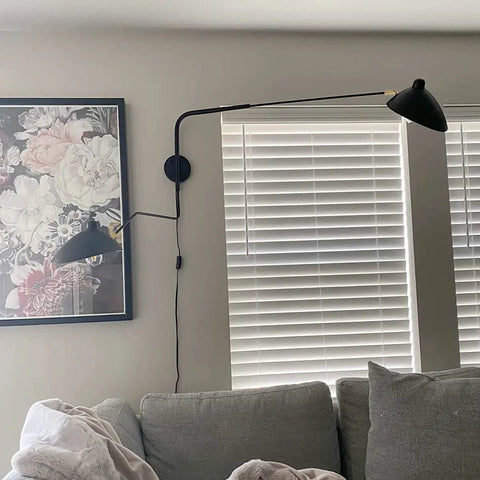 Retro Dope Plug In Wall Sconce With Swivel Arm And Adjustable Head in living room next to abstract art and blinds.