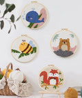 Punch Needle Kit for Adults Beginners With Adjustable Wooden Handle Tools 11 Punch Needle Sizes displayed in embroidery hoops with animal motifs.
