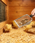 Hand using 2 Pack Chicken Poop Scoopers For Coop Cleanup, Dual Mesh Shovel Set With 3.8mm And 5mm Holes in coop with chicks