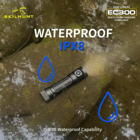 EC300 2600 Lumen Rechargeable LED Flashlight With Red Green Blue White RGB Flood Beam lying on wet rocky surface, showing waterproof feature