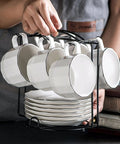 Person holding Tea Cup Holder For Countertop And Display Stand Foldable Metal Rack For Saucers And Espresso Cups decor organizer