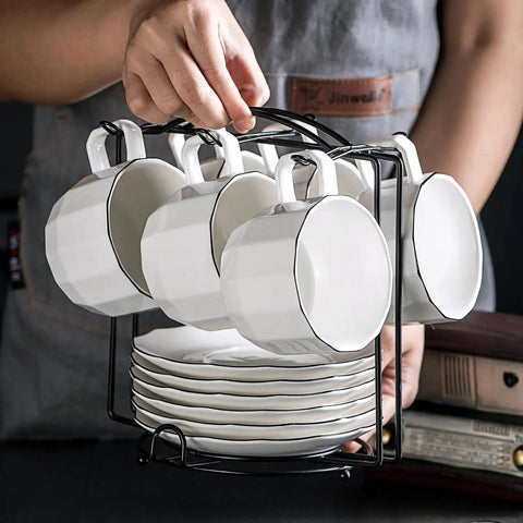 Person holding Tea Cup Holder For Countertop And Display Stand Foldable Metal Rack For Saucers And Espresso Cups decor organizer