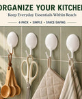 Heavy Duty Adhesive Wall Hooks For Bathroom And Kitchen No Drill Strong Sticky Hangers For Towels Coats Zero Hassle Residue Free 4 Pack on green tiled wall holding measuring spoons, scissors, and kitchen towels.