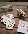 Mini Biplane 3D Puzzle Kit For Adults, wooden mechanical model, with parts and instructions on a table