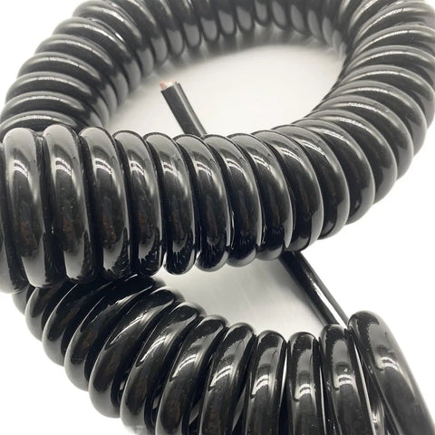 Tough As Nails Coiled Extension Cord With 6 Meter Extra Reach, Heavy Duty 4 Core Pure Copper Spiral Power Cable, close-up of coiled black cable.