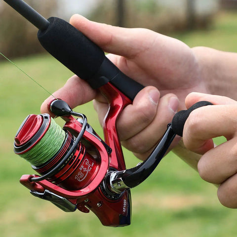 Person holding Lightweight Spinning Reel With 13 Plus 1BB For Saltwater And Freshwater Use Ultra Smooth Action CNC Aluminum Spool and Strong Graphite Frame