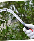 Gloved hand using Two Piece Portable Reaping Hook For Gardening And Mowing Ergonomic Grip For No Sweat Weeding And Harvesting