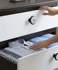 Hands opening dresser with Coastal Beach Vase Hydrangea Round Cabinet Knobs Set Of 4 For Dresser And Kitchen Cupboard.