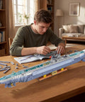 Person assembling Epic WW2 U Boat Submarine Model Kit For Adults With 6172 Pieces, RC Sub Build Set on a table