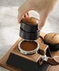 Hand using Espresso Tamper 58.35mm Professional Hand Tamper With Slow Rebound Spring Return Adjustable Depth Palm Grip Stainless Steel Threaded Base Coffee Tamper For Home Brew Latte Art Ready Barista Grade on coffee grounds in portafilter.