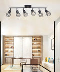 Black 6 Light Farmhouse Track Lighting Fixture With Metal Cage Design installed on ceiling in modern living room