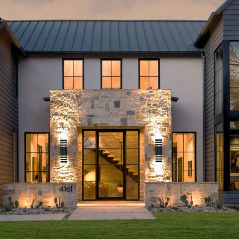 Up And Down Outdoor Wall Light Dual Sconce in Black illuminating modern house exterior at dusk