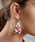 Dope Poker Suit Dangle Drop Earrings Featuring Bold Grid Card Pattern Silver Plated Hooks Lightweight Acrylic Teardrops Hypoallergenic worn on ear of woman.