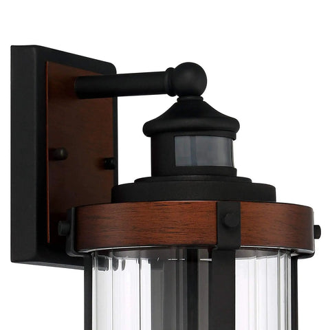 Rock Solid Black Motion Sensor Outdoor Wall Sconce With Zero Fuss Industrial Craftsmanship And Reliable Nighttime Security Lighting For Front Porch Or Driveway close-up of motion sensor on heavy-duty fixture