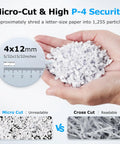 Hands holding micro-cut shredded paper particles, showcasing P-4 security level achieved by Two In One 300 Sheet Auto Feed Paper Shredder.