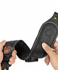 Hands holding a slip on rifle sling with cartridge holder leather gun strap with swivels and thumb loop adjustable carry strap with no slip backing