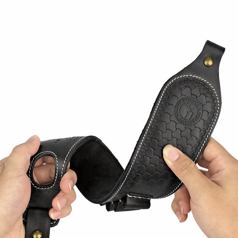 Hands holding a slip on rifle sling with cartridge holder leather gun strap with swivels and thumb loop adjustable carry strap with no slip backing