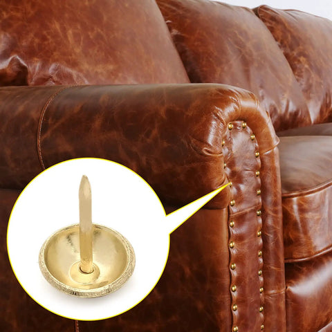 Upgrade Your Furniture Game With These Top Shelf Gold Upholstery Tacks 300 Piece Kit Featuring A Crisp 0.43 Inch Round Head And Easy Install Design delivering a close-up view of a gold tack on leather.