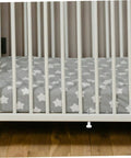 Close-up of crib base with visible Four Pack Crib Latch Window Screen Pin Set Spring Loaded Bed Latches for small cribs.