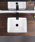 White Rectangle Vessel Sink For Bathroom Above Counter Porcelain Ceramic Basin With Black Rim Edge Modern European Inspired Design 18 Inch Exterior Sleek Small Sink Bowl For Bathrooms top view on wooden countertop with faucet.
