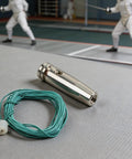 Epee Wire 1m With Point Tip For Easy Fencing Maintenance And Repair Pro Grade High Conductivity Metal Cable on a fencing mat