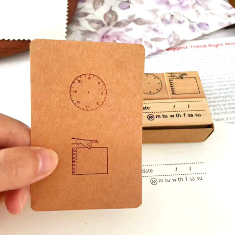 Top Shelf Wooden Stamp Set Featuring Date Time Notes Stamps For Crafting Journaling Planner Organization Durable Natural Wood And Rubber Design Super Slick Ink Application Killer Combo showing analog clock face stamp on kraft card.